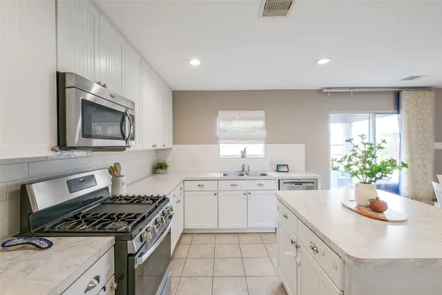 a kitchen with a sink stove and cabinets