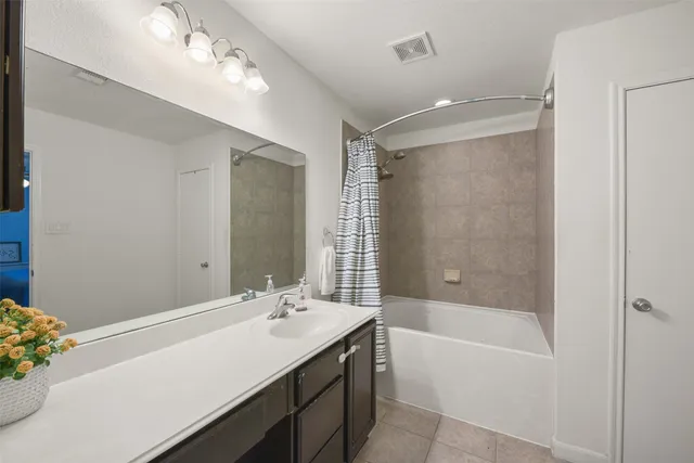 a bathroom with a tub sink and mirror