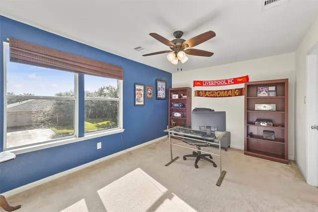 a view of a livingroom with furniture and a window