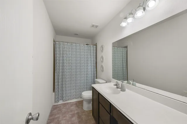 a bathroom with a sink a toilet and mirror