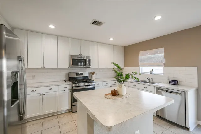 a kitchen with a sink a stove and refrigerator