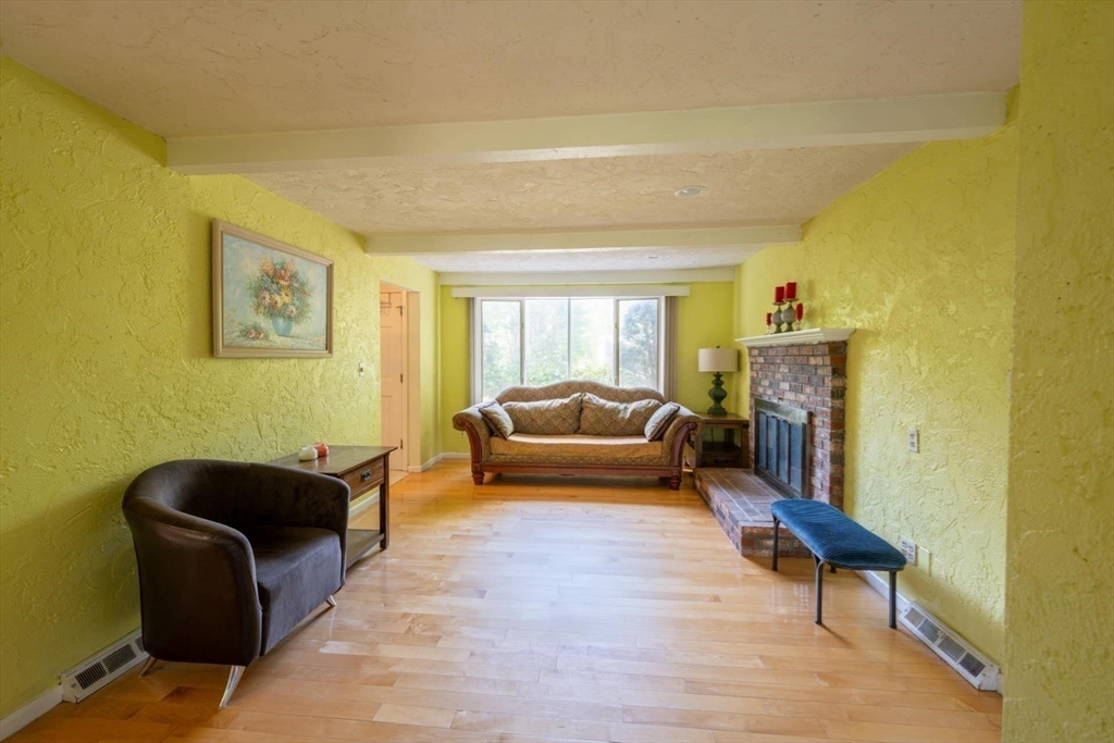 214 Hampton Road Sharon, MA 02067 - Photo 8 of 24 a living room with furniture and a fireplace