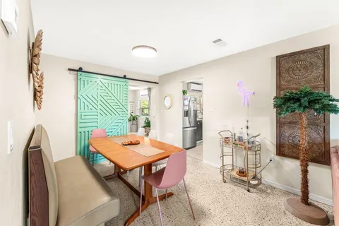 a dining room with furniture and window