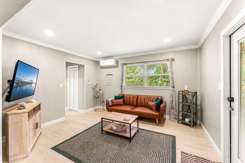 a living room with furniture a rug and a lamp