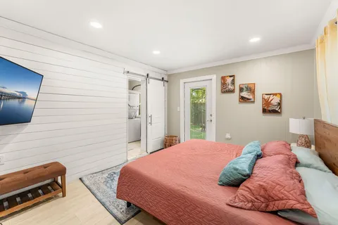 a bedroom with a large bed and a chandelier
