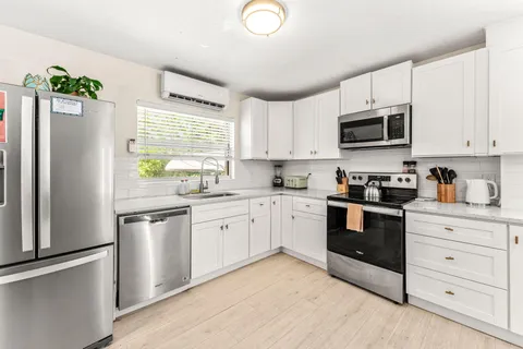 a kitchen with a sink cabinets and window