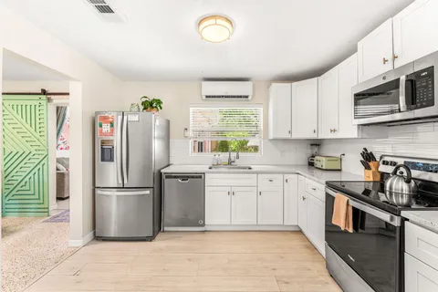 a kitchen that has a table and chairs in it