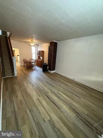 a view of a livingroom with wooden floor and furniture