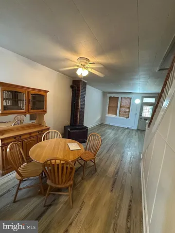 a view of a livingroom with furniture wooden floor and chandelier