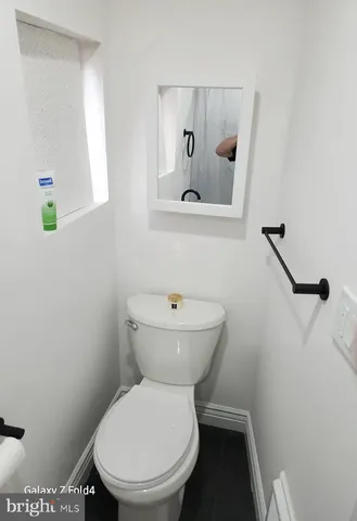 a white toilet sitting next to a bathroom sink
