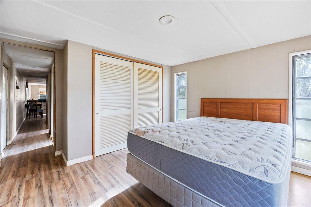 2780 County Road 575 Bushnell, FL 33513 - Photo 16 of 57 a bedroom with a bed and wooden floor