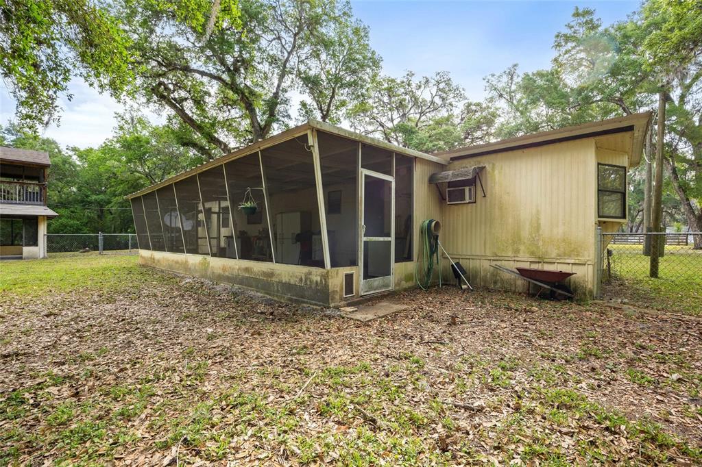 2780 County Road 575 Bushnell, FL 33513 - Photo 23 of 57 a view of a house with a yard and large tree