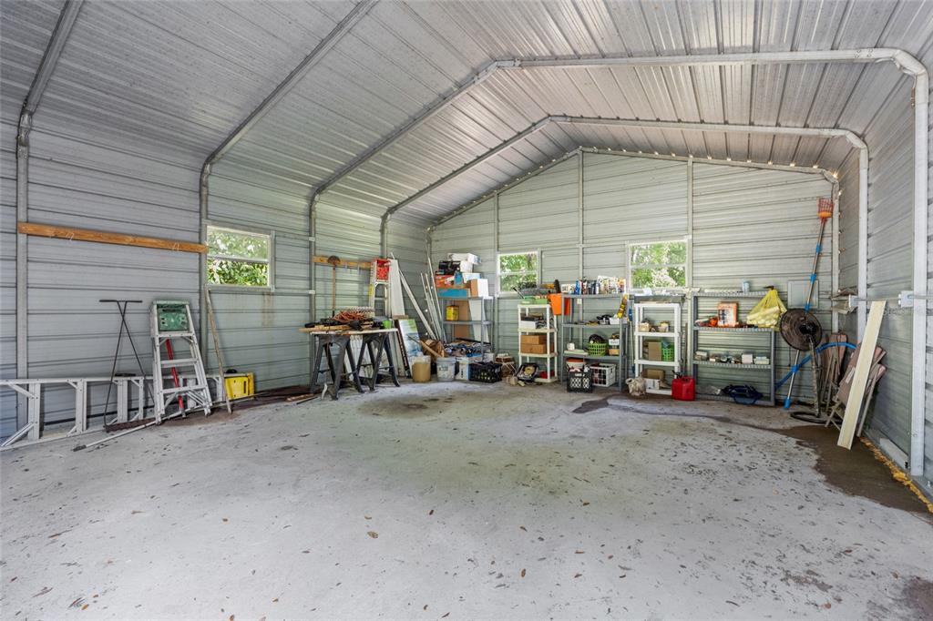 2780 County Road 575 Bushnell, FL 33513 - Photo 28 of 57 a view of a garage with clothes