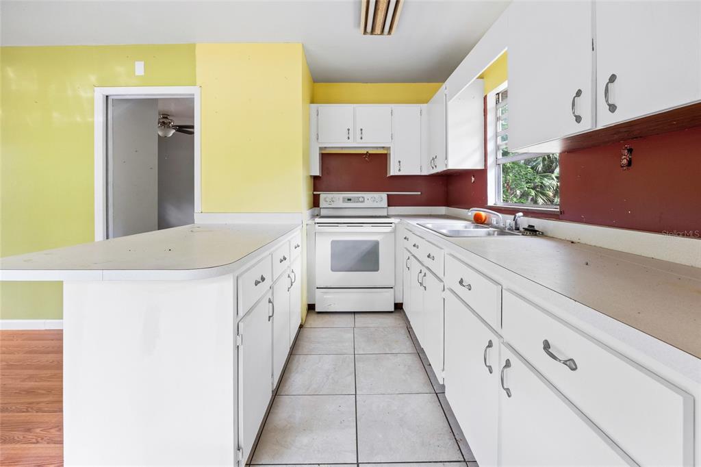 2780 County Road 575 Bushnell, FL 33513 - Photo 40 of 57 a large white kitchen with a stove top oven a sink and dishwasher