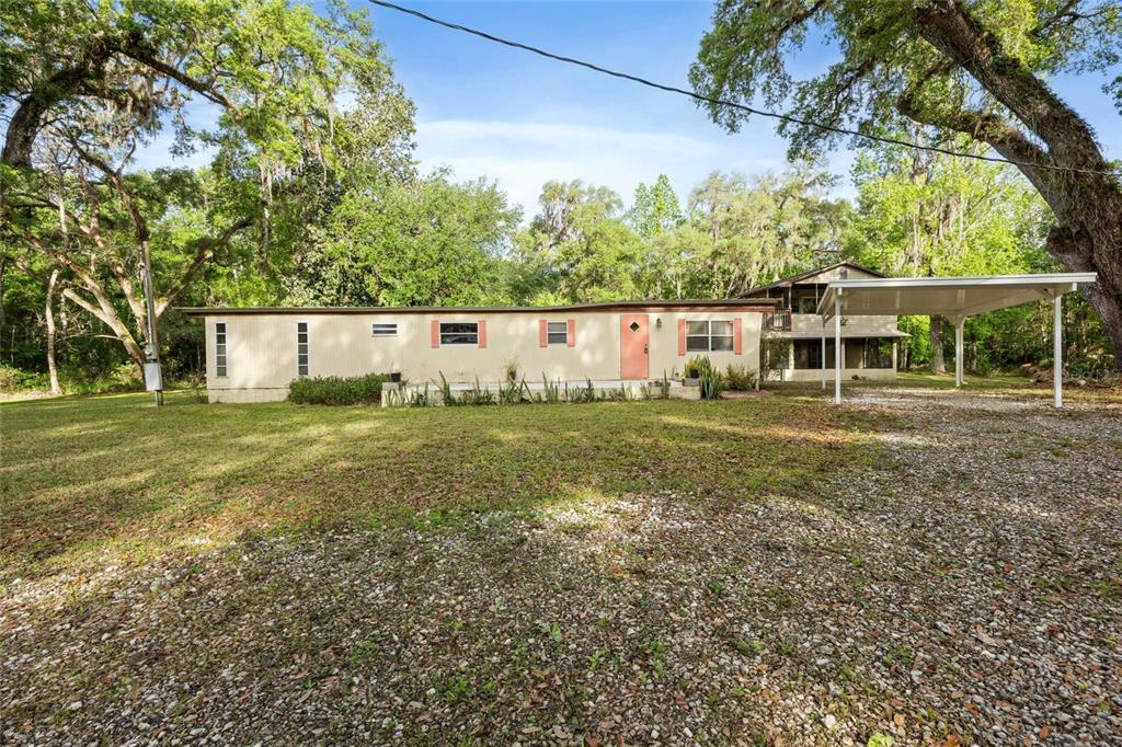 2780 County Road 575 Bushnell, FL 33513 - Photo 4 of 57 a view of an house with backyard space and garden