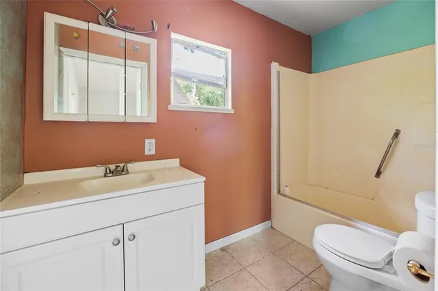 a view of a green field with trees in the background