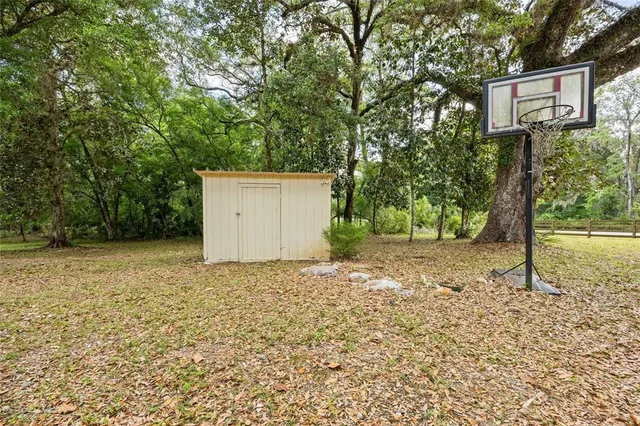a aerial view of a house with large trees