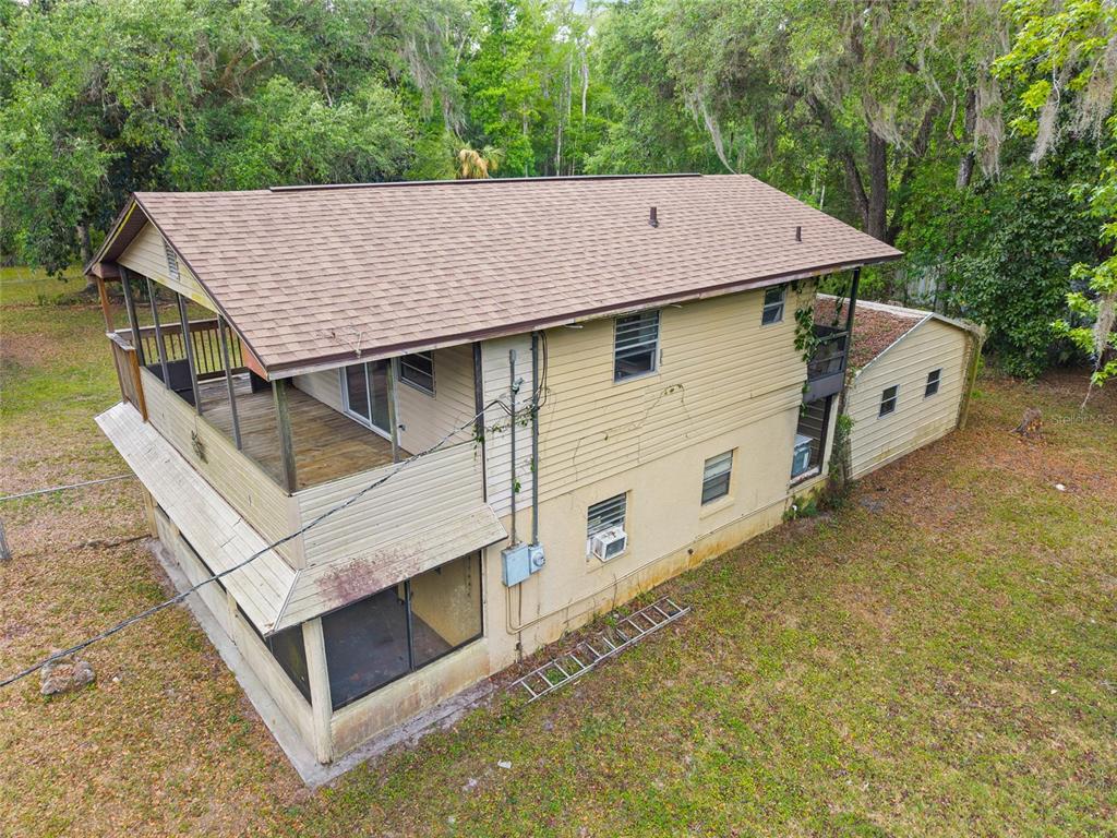 2780 County Road 575 Bushnell, FL 33513 - Photo 50 of 57 a aerial view of a house with large trees