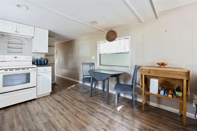 a kitchen with stainless steel appliances a refrigerator a sink and white cabinets