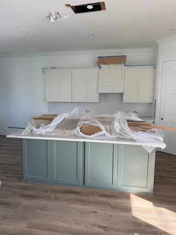a kitchen with granite countertop a sink and a stove
