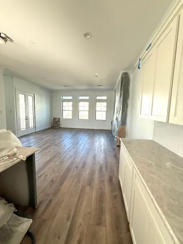 a open kitchen with window and wooden floor