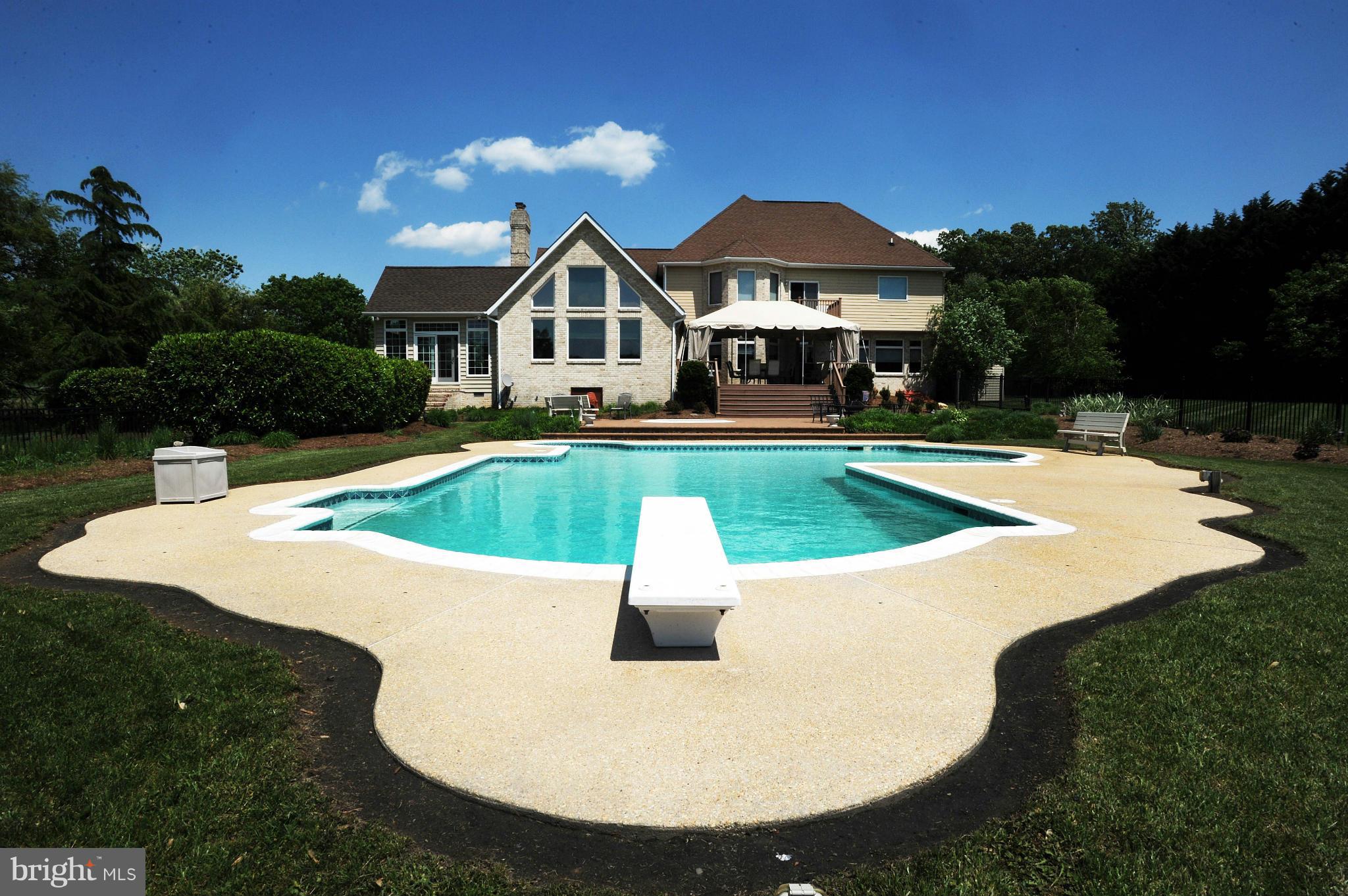 712 Connolly Farms Road Fallston, MD 21047 - Photo 4 of 30 a view of a swimming pool with lawn chairs under an umbrella
