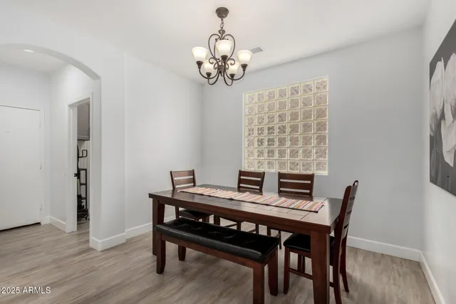 a view of a dining room with furniture wooden floor and a chandelier
