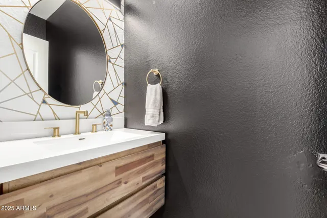 a bathroom with a sink and mirror