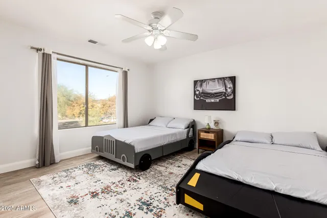 a bedroom with two beds and a large window