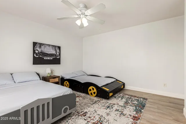 a bedroom with bed and a chandelier