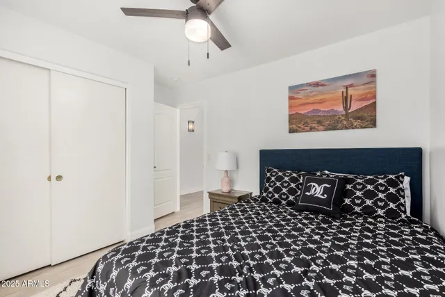 a bedroom with a bed and a black white wall