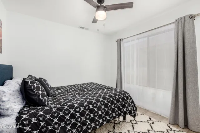 a bedroom with a bed and a window