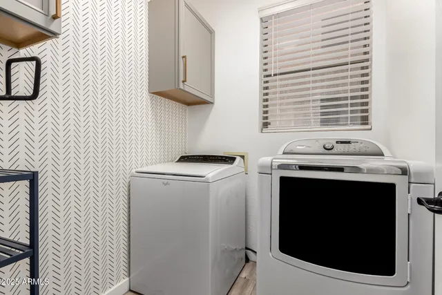 a view of storage and utility room with washer and dryer