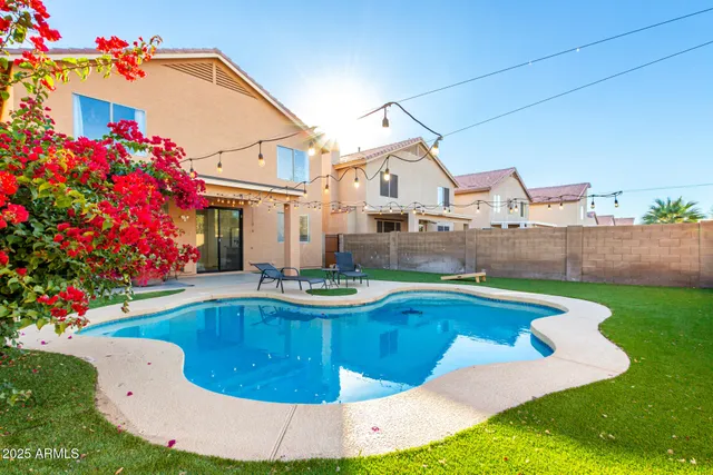 a view of a house with swimming pool yard and outdoor seating