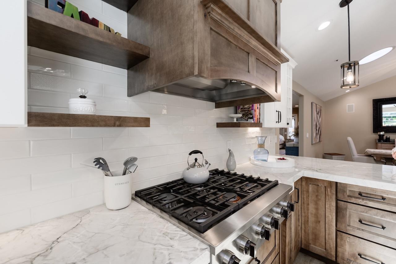 307 Sidesaddle Circle Scotts Valley, CA 95066 - Photo 19 of 116 a kitchen with stainless steel appliances granite countertop a sink a stove and wooden cabinets