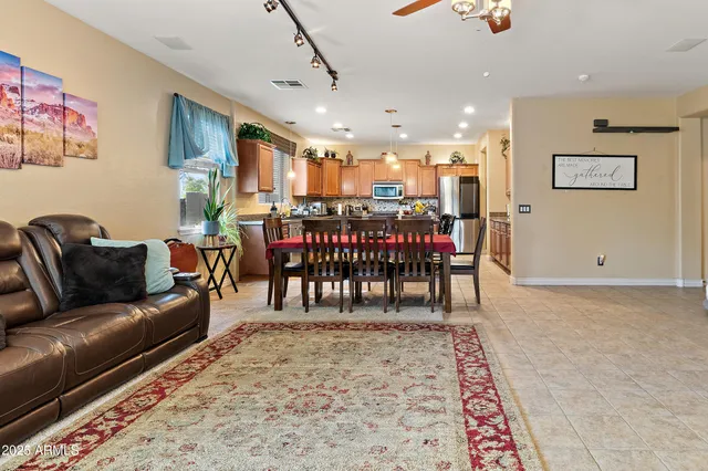 a dining room with furniture and a flat screen tv