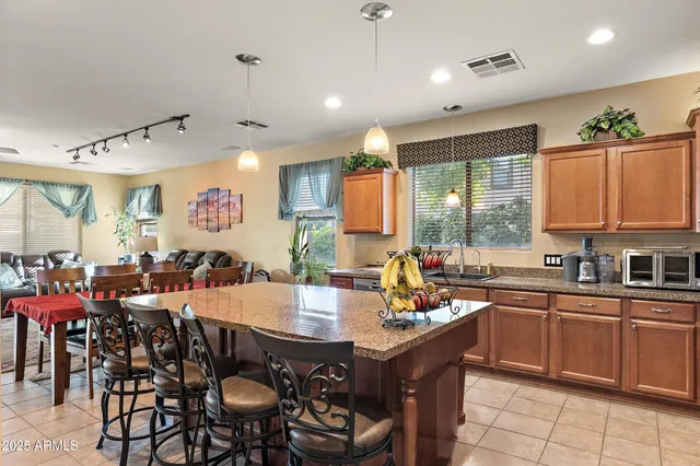 a kitchen with sink refrigerator and microwave