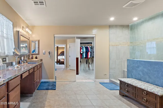 a bathroom with a granite countertop shower a sink and a stove
