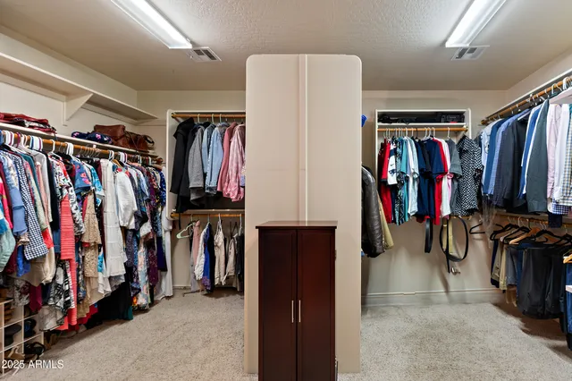 a bedroom with a bed and a ceiling fan