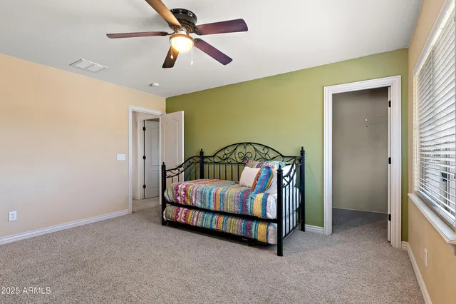 a view of a livingroom with furniture and book shelf