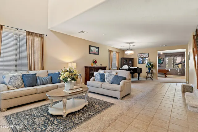 a living room with furniture potted plant and a window