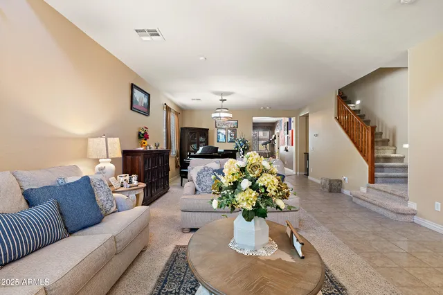a living room with furniture and a dining table with wooden floor