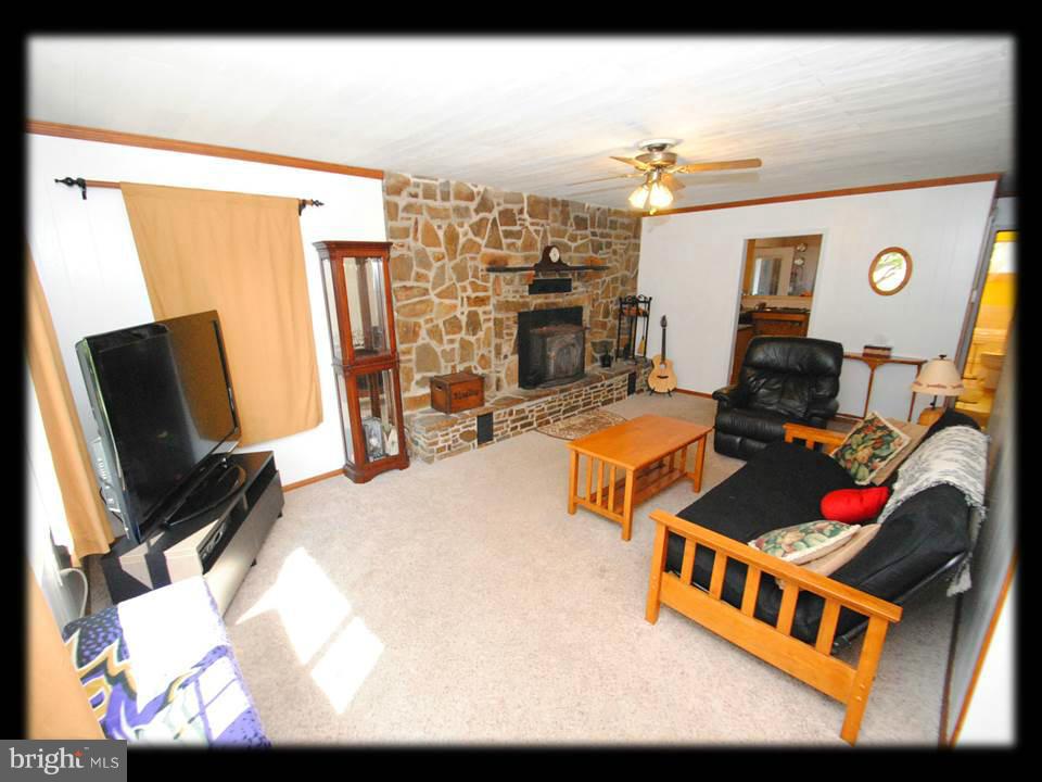 210 North Branch Road Baltimore, MD 21222 - Photo 13 of 30 LARGE LIVING ROOM W/CUSTOM STONE WALL FIREPLACE