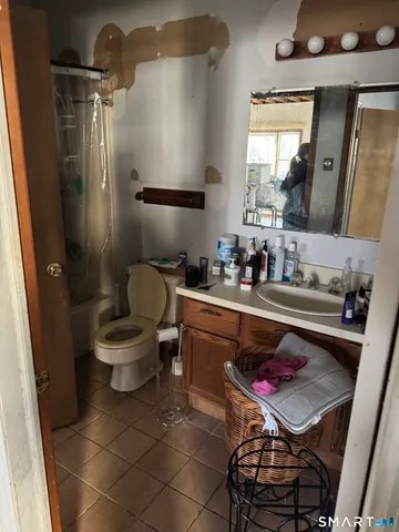 a bathroom with a sink toilet and mirror