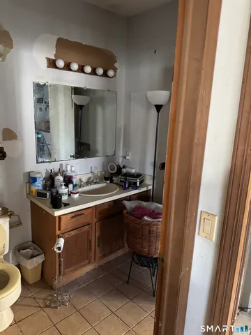 a view of a kitchen with fridge and workspace