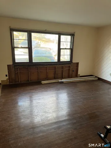 a view of wooden floor and windows in a room