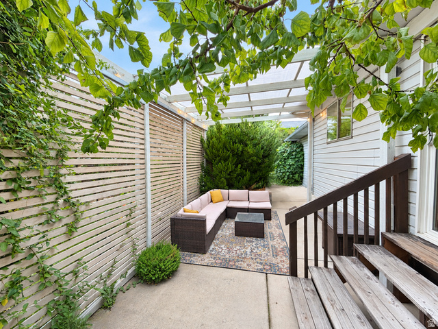 452 North 600 East Springville, UT 84663 - Photo 24 of 26 Private concrete patio with a slatted privacy fence and a white pergola