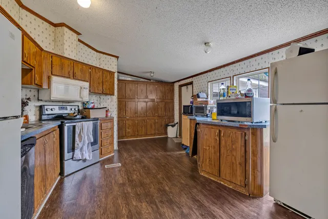 a kitchen with stainless steel appliances a refrigerator and a stove top oven
