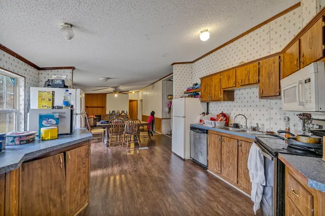 a kitchen with lots of counter top space and wooden floor