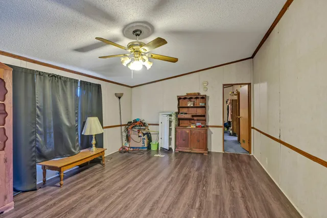 a bedroom with furniture and wooden floor